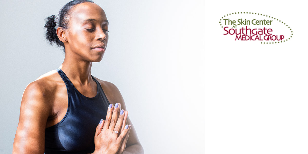 SOUTHGATE_SKIN_CENTER_PREVENTATIVE_BOTOX Preventative Botox: A young woman closes her eyes and presses her hands together in a yoga health position.